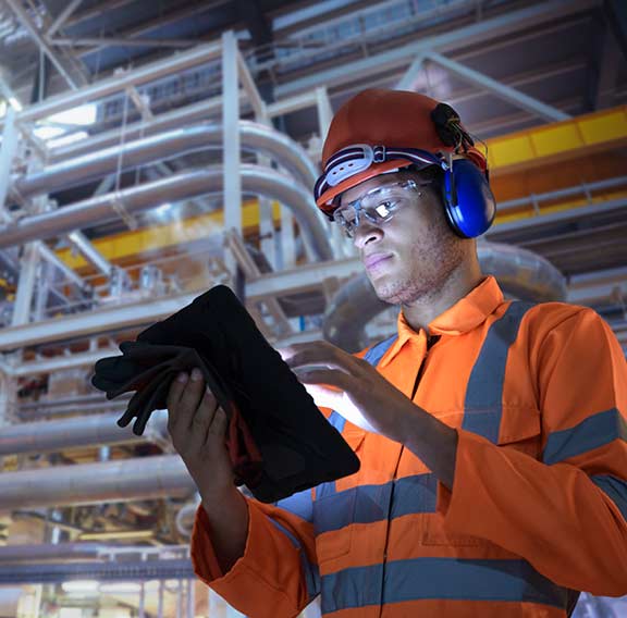 Engineer in nuclear power station using digital tablet